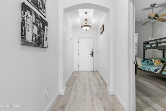 corridor with light hardwood / wood-style flooring