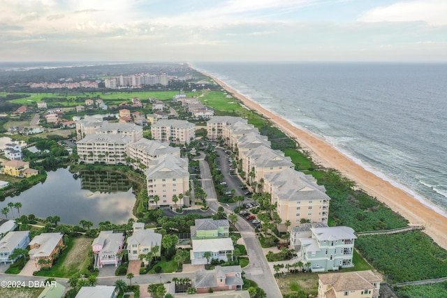 birds eye view of property with a view of the beach and a water view