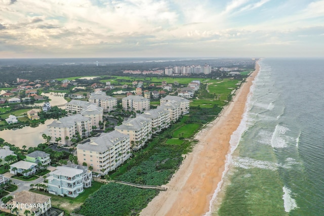 birds eye view of property featuring a water view and a beach view