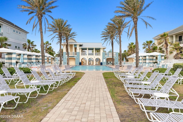 exterior space with a balcony and a community pool