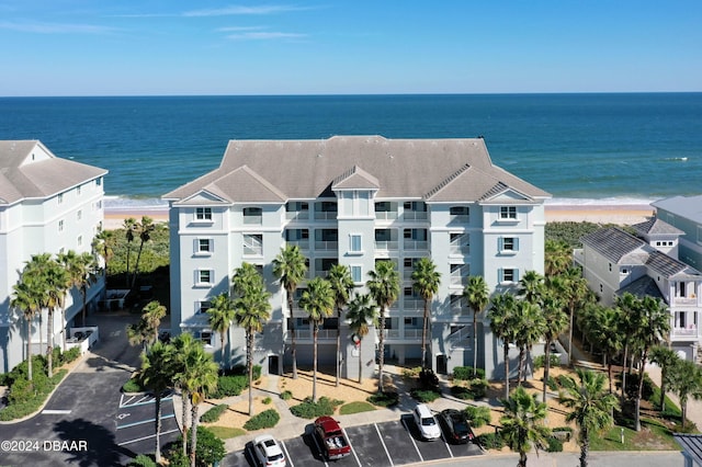 drone / aerial view featuring a water view and a beach view