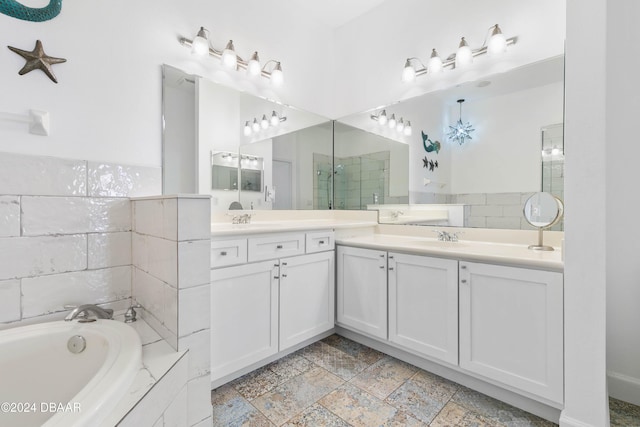 bathroom with vanity and shower with separate bathtub