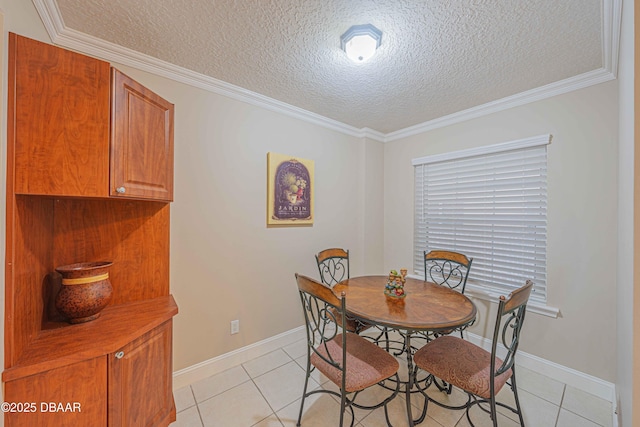 tiled dining space featuring a textured ceiling and ornamental molding