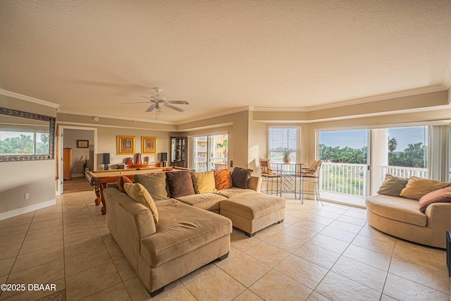 tiled living room with ceiling fan, ornamental molding, and a textured ceiling