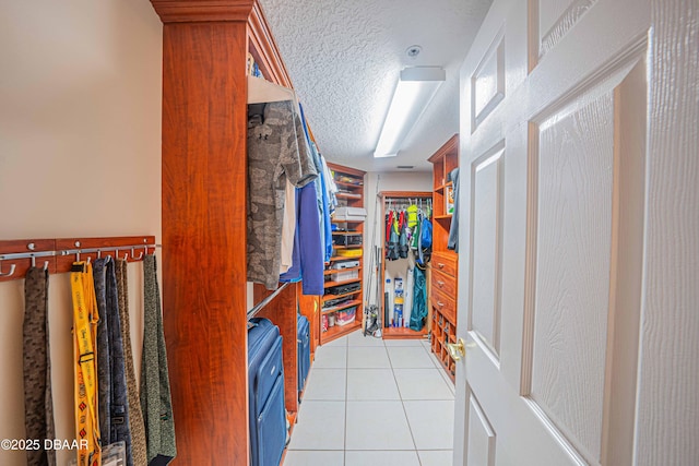 walk in closet with light tile patterned floors