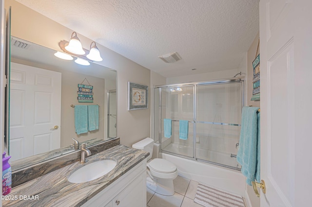 full bathroom featuring a textured ceiling, enclosed tub / shower combo, tile patterned floors, vanity, and toilet