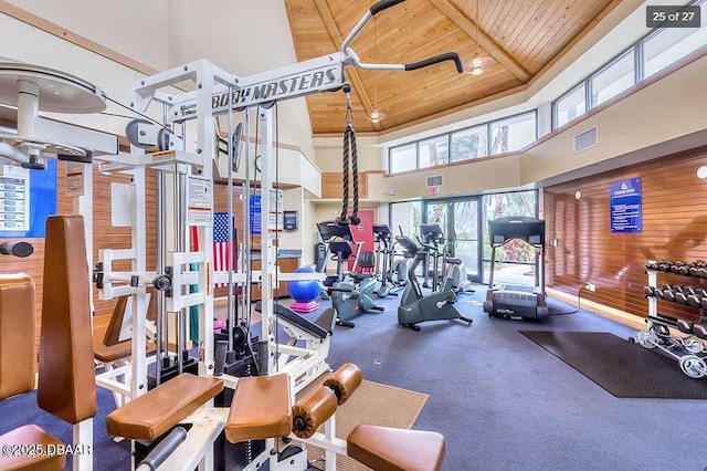 workout area with a towering ceiling and wooden ceiling