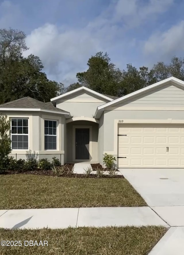 ranch-style house featuring a garage, driveway, a front lawn, and stucco siding