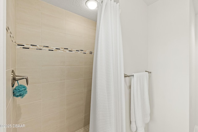 3721 S Atlantic Ave Unit 801, Daytona Beach Shores, FL 32116 - full bath featuring a tile shower and a textured ceiling