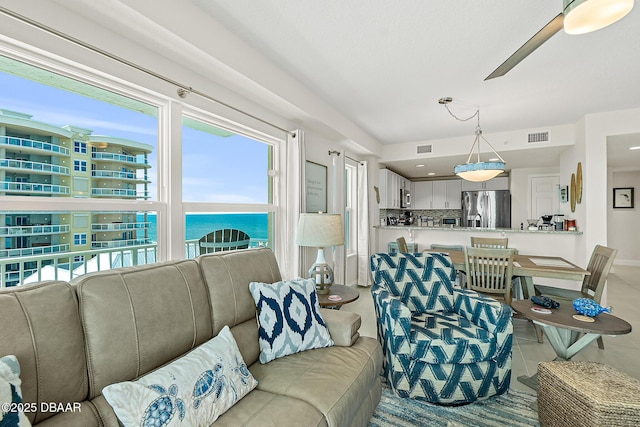 3721 S Atlantic Ave Unit 801, Daytona Beach Shores, FL 32116 - living room featuring a ceiling fan and light tile patterned floors