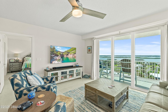 3721 S Atlantic Ave Unit 801, Daytona Beach Shores, FL 32116 - living room with a ceiling fan, tile patterned flooring, and a textured ceiling