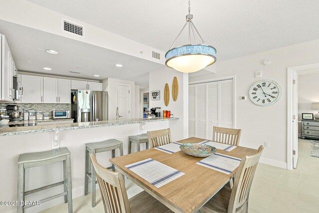 3721 S Atlantic Ave Unit 801, Daytona Beach Shores, FL 32116 - dining room with recessed lighting and light tile patterned flooring