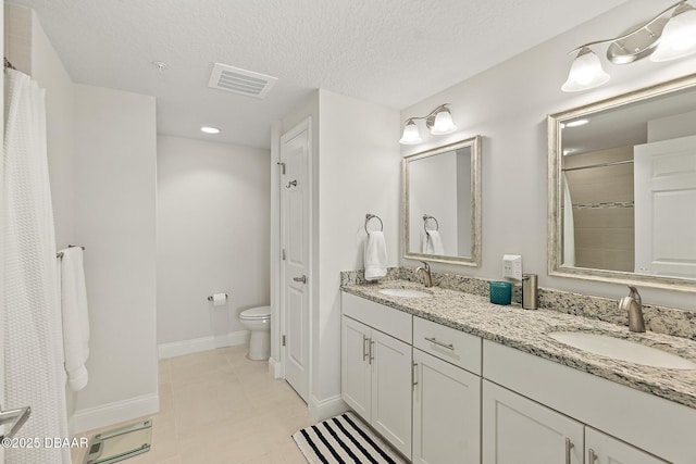3721 S Atlantic Ave Unit 801, Daytona Beach Shores, FL 32116 - full bath with double vanity, tile patterned flooring, a textured ceiling, and a shower with shower curtain