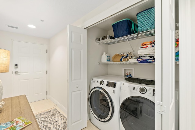 3721 S Atlantic Ave Unit 801, Daytona Beach Shores, FL 32116 - washroom featuring separate washer and dryer, light tile patterned floors, and recessed lighting