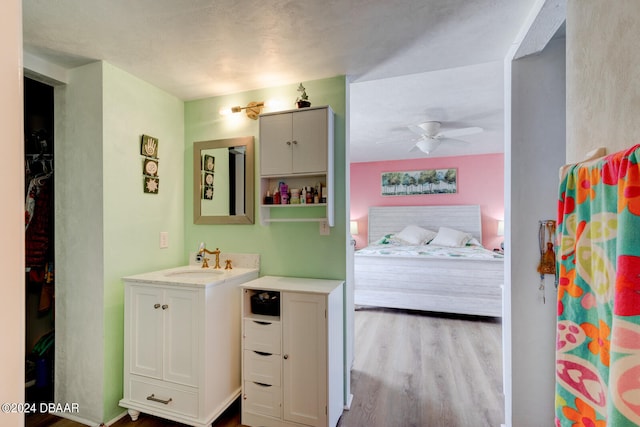 bathroom featuring vanity, hardwood / wood-style flooring, and ceiling fan