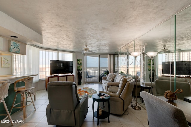 living room with light tile patterned flooring, floor to ceiling windows, and ceiling fan