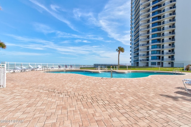 view of swimming pool with a water view