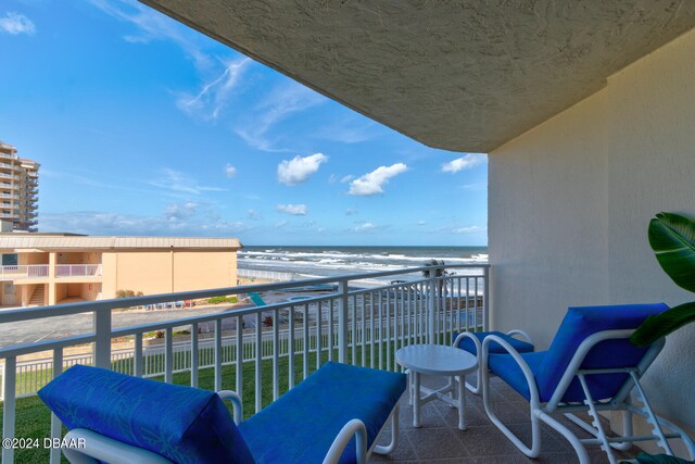 balcony with a view of the beach and a water view