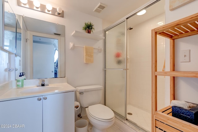 bathroom with toilet, vanity, an enclosed shower, and tile patterned flooring