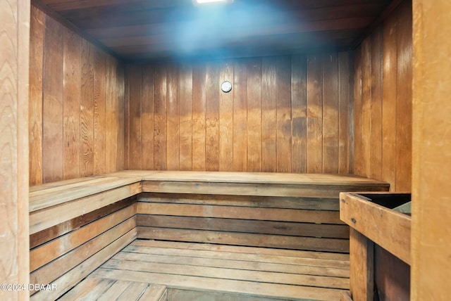 view of sauna / steam room featuring wooden walls and wooden ceiling