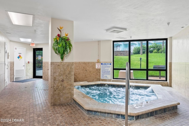 view of pool with an indoor hot tub