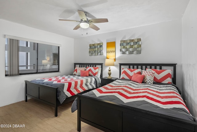 bedroom with light wood-type flooring and ceiling fan