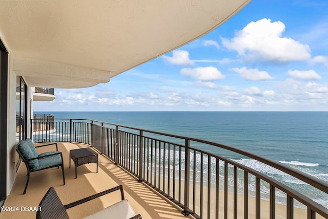 balcony with a view of the beach and a water view