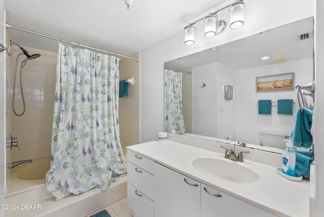 full bathroom featuring tile patterned flooring, vanity, toilet, and shower / tub combo with curtain