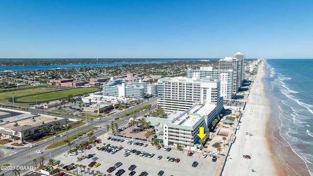 drone / aerial view with a beach view and a water view