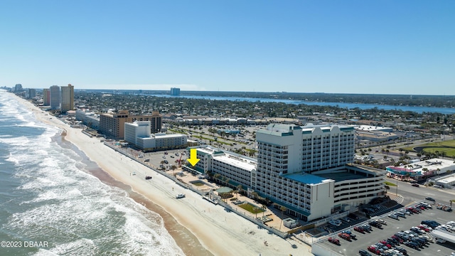 bird's eye view featuring a water view and a beach view