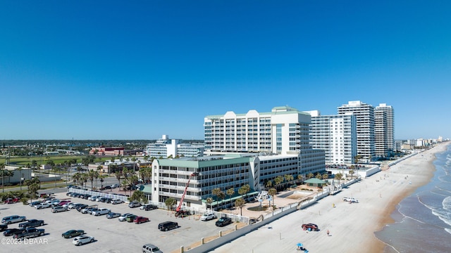 drone / aerial view with a water view and a beach view