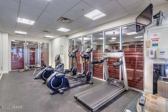 exercise room featuring a drop ceiling