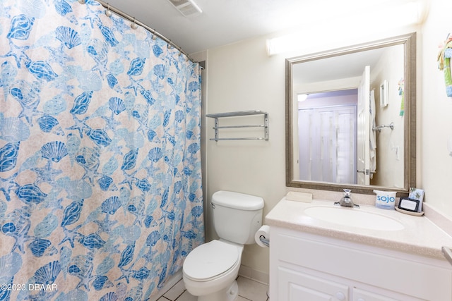 bathroom featuring vanity, toilet, and tile patterned flooring