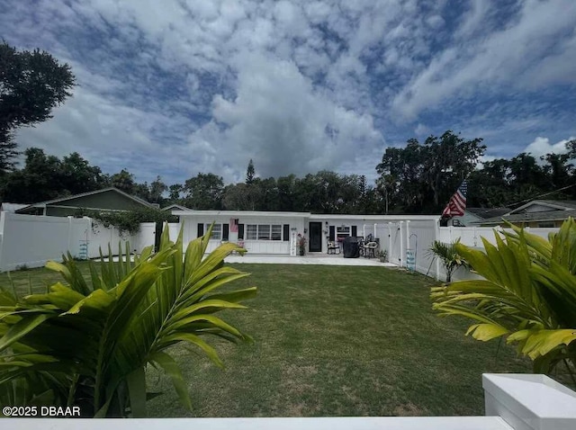 back of property featuring a patio area, a fenced backyard, and a yard