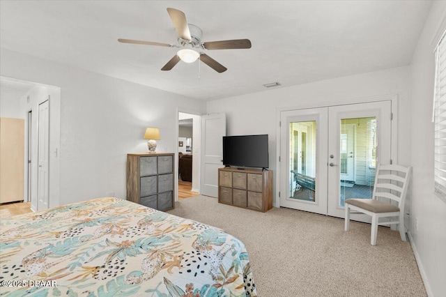 bedroom featuring light carpet, access to exterior, french doors, and ceiling fan