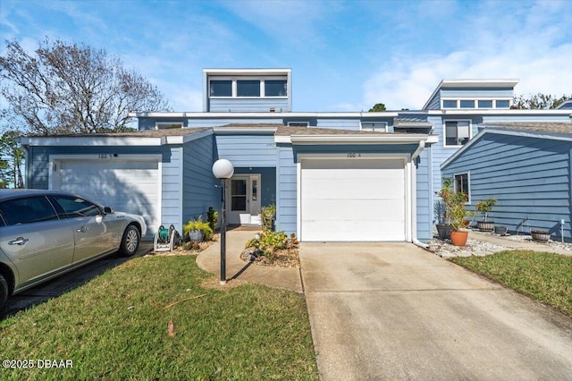 view of front of home featuring a garage and a front lawn