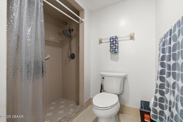 bathroom featuring tile patterned floors, toilet, and a shower with shower curtain