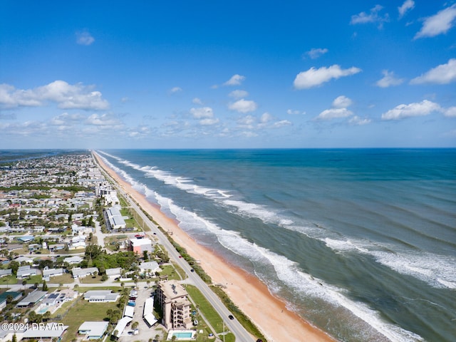 birds eye view of property with a beach view and a water view