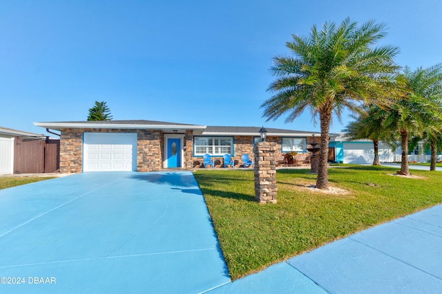 view of front of house with a garage and a front yard