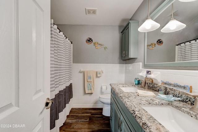 bathroom featuring tile walls, vanity, hardwood / wood-style floors, a shower with shower curtain, and toilet