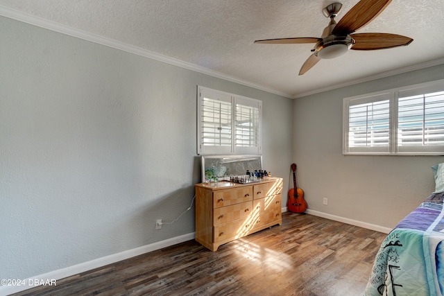 bedroom with ceiling fan, multiple windows, dark hardwood / wood-style flooring, and crown molding