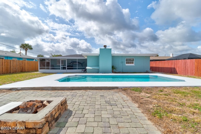 view of pool with a patio area and a sunroom