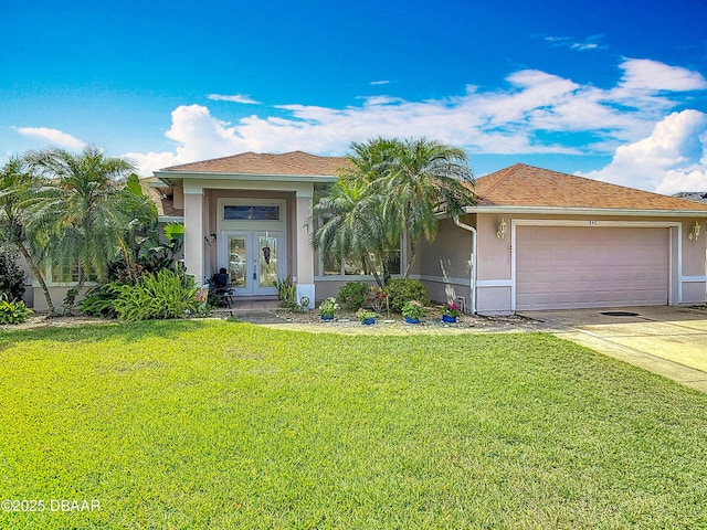 1840 Tara Marie Ln, Port Orange, FL 32128 - view of front of property with french doors, stucco siding, a garage, and a front yard