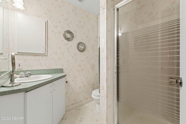 bathroom featuring walk in shower, vanity, and toilet