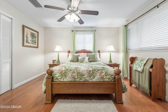 bedroom with ceiling fan, a closet, and light wood-type flooring