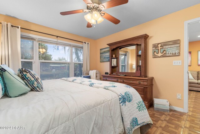 bedroom featuring ceiling fan and parquet floors