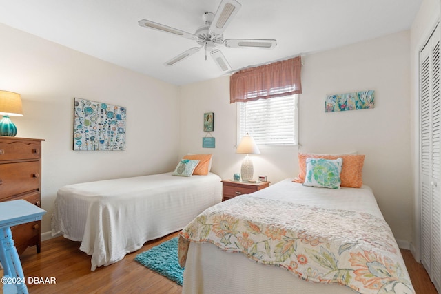 bedroom with wood-type flooring, a closet, and ceiling fan