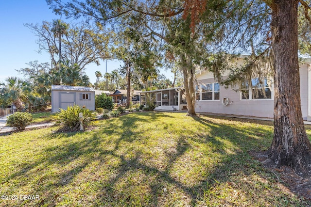 view of yard featuring a storage unit and a sunroom