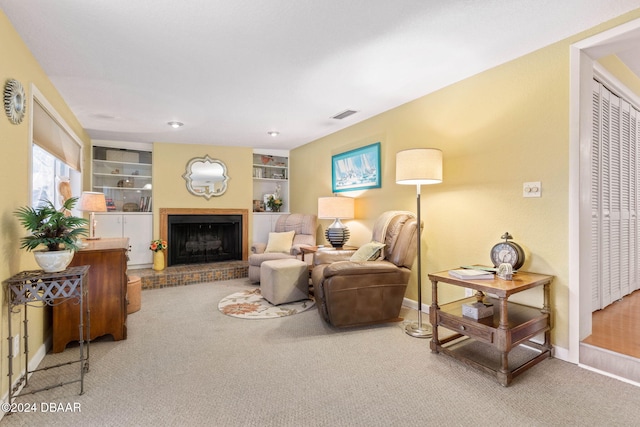 carpeted living room with a fireplace and built in shelves