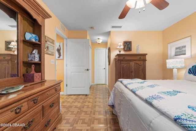 bedroom with ceiling fan and light parquet flooring